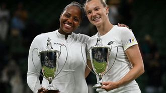 Winners USA's Taylor Townsend (L) and Czech Republic's Katerina Siniakova pose with their trophies following their victory against Canada's Gabriela Dabrowski and New Zealand's Erin Routliffe at the end of their women's doubles final tennis match on the thirteenth day of the 2024 Wimbledon Championships at The All England Lawn Tennis and Croquet Club in Wimbledon, southwest London, on July 13, 2024. 
Ben Stansall / AFP