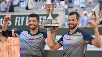 Salvador's Marcelo Arevalo (L) and Croatia's Mate Pavic celebrate after winning against Italy's Simone Bolelli and Andrea Vavassori at the end of their men's doubles final match on Court Philippe-Chatrier on day fourteen of the French Open tennis tournament at the Roland Garros Complex in Paris on June 8, 2024. 
Bertrand GUAY / AFP