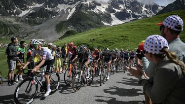 UAE Team Emirates team's Slovenian rider Tadej Pogacar (L) and Red Bull - BORA - hansgrohe team's Slovenian rider Primoz Roglic (2nd L) cycle with the pack of riders (peloton) in the Galibier ascent during the 4th stage of the 111th edition of the Tour de France cycling race, 140 km between Pinerolo in Italy, and Valloire in France, on July 2, 2024. 
Marco BERTORELLO / AFP