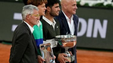 (From L) French Tennis Federation's President Gilles Moretton, second-placed Italy's Jannik Sinner, Winner Spain's Carlos Alcaraz and former US tennis player Andre Agassi pose with the trophies on the podium of the men's singles final match on day 15 of the French Open tennis tournament on Court Philippe-Chatrier at the Roland-Garros Complex in Paris on June 8, 2025. 
Dimitar DILKOFF / AFP