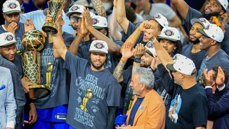 epa13035766 New York Knicks guard Jalen Brunson (C) holds up the Bill Russell MVP award after winning Game 5 of the NBA Finals between the San Antonio Spurs and the New York Knicks, San Antonio, USA, 13 June 2026.  EPA/ADAM DAVIS  SHUTTERSTOCK OUT