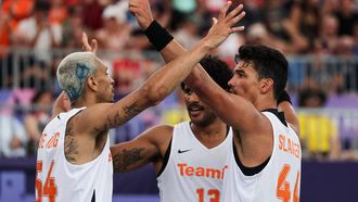 (From L) Netherlands' #54 Worthy de Jong, Netherlands' #13 Dimeo van der Horst and Netherlands' #44 Arvin Slagter celebrate after winning the men's pool round 3x3 basketball game between the Netherlands and Lithuania during the Paris 2024 Olympic Games at La Concorde in Paris on August 2, 2024. 
David GRAY / AFP