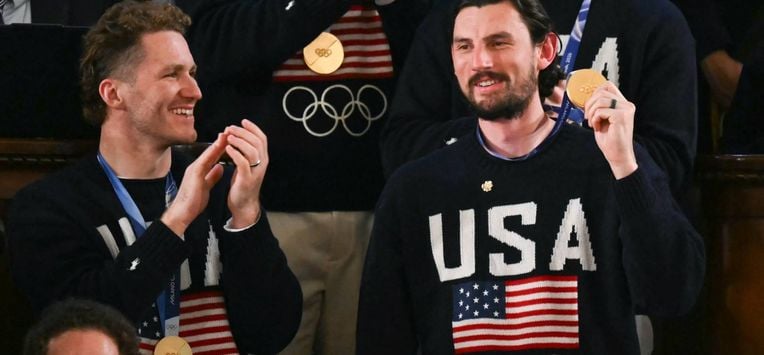 Goalie Connor Hellebuyck raises his gold medal as members of the US Men's Olympic hockey team are recogized by US President Donald Trump as he delivers the State of the Union address in the House Chamber of the US Capitol in Washington, DC, on February 24, 2026. 
ANDREW CABALLERO-REYNOLDS / AFP