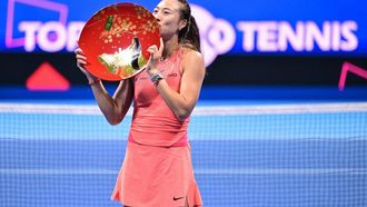 China’s Zheng Qinwen kisses the winner's trophy after her victory over Sofia Kenin of the US in their women's singles final match at the Pan Pacific Open tennis tournament in Tokyo on October 27, 2024. 
Yuichi YAMAZAKI / AFP