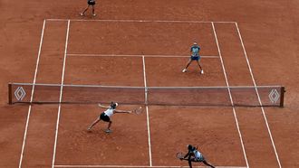 epa09996975 Coco Gauff and Jessica Pegula (front R-L) of the USA play Caroline Garcia and Kristina Mladenovic of France (back R-L) in their Womens’ Doubles final match during the French Open tennis tournament at Roland ​Garros in Paris, France, 05 June 2022.  EPA/CHRISTOPHE PETIT TESSON