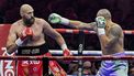 Britain's Tyson Fury (red) and Ukraine's Oleksandr Usyk (blue) compete during their heavyweight world championship rematch at the Kingdom Arena in Riyadh on December 22, 2024. 
AFP
