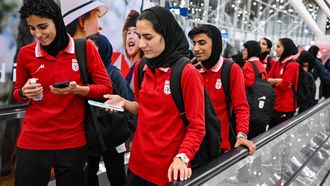 Members of Iran's women's football team walk as they arrive at the Kuala Lumpur International Airport after taking part in the AFC Women’s Asian Cup Australia 2026 tournament in Australia, in Sepang on March 11, 2026. At least five players from Iran's visiting women's football team claimed asylum in Australia on on March 10, seeking protection after they were branded 
