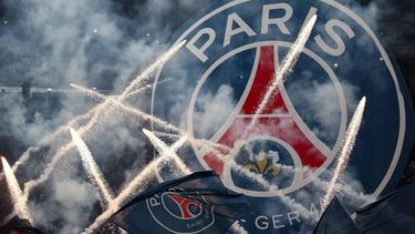 Flags and banners with the PSG logo are waved as fireworks are set off during a show prior to the French Cup final football match between Paris Saint-Germain (PSG) and Stade de Reims at the Stade de France in Saint-Denis, north of Paris, on May 24, 2025.  
FRANCK FIFE / AFP