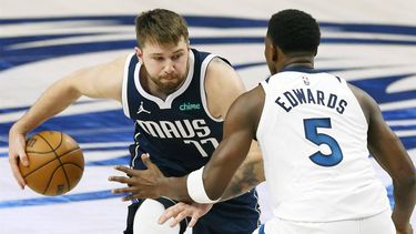 epa11376587 Dallas Mavericks guard Luka Doncic (L) dribbles past Minnesota Timberwolves forward Anthony Edwards (R) during the first half of the NBA Western Conference Finals playoff game four between the Minnesota Timberwolves and the Dallas Mavericks in Dallas, Texas, USA, 28 May 2024.  EPA/ADAM DAVIS SHUTTERSTOCK OUT
