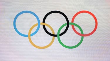 The photograph shows Olympic Rings during a ceremony to mark one year until the start of Milano Cortina Olympics in Strehler Theatre, in Milan, on February 6, 2025, ahead of the Milano Cortina 2026 Winter Olympic and Paralympic Games. 
MARCO BERTORELLO / AFP