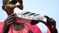 Kenya's Sabastian Sawe poses with his new world record time written on his running shoe at the finish of the 2026 London Marathon in central London on April 26, 2026. Kenya's Sabastian Sawe broke the two-hour mark for the first time in history on Sunday in winning the London Marathon.
JUSTIN TALLIS / AFP