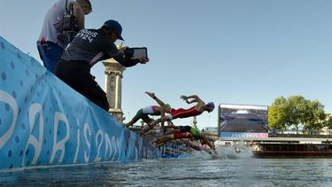 Athletes jump into the water to compete in the swimming race in the Seine, during the mixed's relay triathlon, at the Paris 2024 Olympic Games, in central Paris, on August 5, 2024. 
MARTIN BUREAU / POOL / AFP