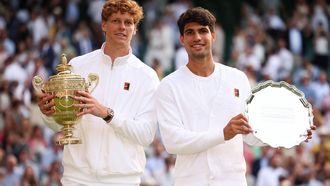 Italy's Jannik Sinner (L) holding the winner's trophy and second-placed Spain's Carlos Alcaraz pose for pictures during the price ceremony at the end of their men's singles final tennis match on the fourteenth day of the 2025 Wimbledon Championships at The All England Lawn Tennis and Croquet Club in Wimbledon, southwest London, on July 13, 2025. 
HENRY NICHOLLS / AFP