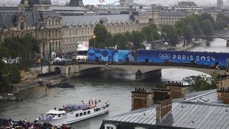 Paris 2024 Olympics - Opening Ceremony - Paris, France - July 26, 2024. Athletes of South Korea, Ivory Coast, Costa Rica and Democratic Republic of Congo aboard a boat in the floating parade pass the Musee du Louvre on the river Seine during the opening ceremony. 
Peter Cziborra / POOL / AFP
