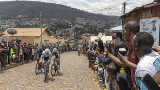 Residents gather to look at cyclists competing during the final stage of the 16h Tour du Rwanda on 25 february 2024, in Kigali. Israel Premier Tech’s British rider Joseph Blackmore, won the Tour of Rwanda which ended on Sunday in the capital Kigali. 
Guillem Sartorio / AFP