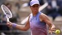 Poland's Iga Swiatek eyes the ball as she plays against Britain's Emma Raducanu during their women's singles match on day 4 of the French Open tennis tournament on Court Philippe-Chatrier at the Roland-Garros Complex in Paris on May 28, 2025. 
JULIEN DE ROSA / AFP