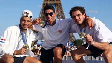 Netherlands' 3x3 basketball gold medallists Worthy de Jong, Arvin Slagter, and Jan Driessen pose with their medals on stage at the Champions Park at Trocadero during the Paris 2024 Olympic Games in Paris on August 6, 2024, with the Eiffel Tower visible in the background. 
Jack GUEZ / AFP