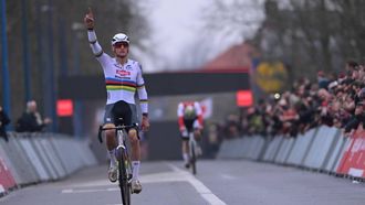 Dutch Mathieu Van Der Poel celebrates as he crosses the finish line to win the men's elite race of the 6th stage of the world cup cyclocross, in Koksijde on December 21, 2025. 
DAVID PINTENS / Belga / AFP