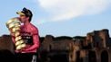 Team Visma-Lease a Bike's British rider Simon Yates wearing the pink jersey of overall leader (Maglia Rosa) celebrates holding the Trofeo Senza Fine on the podium after the 21st and last stage and winning the 108th Giro d'Italia cycling race of 143kms from Rome to Rome on June 1, 2025. 
Luca Bettini / AFP