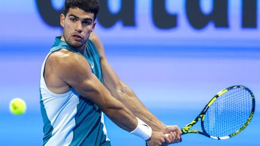 Spain's Carlos Alcaraz hits a return to Italy's Luca Nardi during their men's singles match at the ATP Qatar Open tennis tournament in Doha on February 19, 2025. 
KARIM JAAFAR / AFP