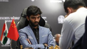 epa11771894 Chess grandmasters Gukesh Dommaraju (facing) of India and Ding Liren of China compete in Game 14 of the FIDE World Chess Championship in Singapore, 12 December 2024.  EPA/HOW HWEE YOUNG