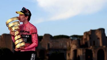 Team Visma-Lease a Bike's British rider Simon Yates wearing the pink jersey of overall leader (Maglia Rosa) celebrates holding the Trofeo Senza Fine on the podium after the 21st and last stage and winning the 108th Giro d'Italia cycling race of 143kms from Rome to Rome on June 1, 2025. 
Luca Bettini / AFP