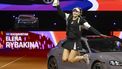 Kazakhstan's Elena Rybakina holds her trophy as she jumps inf front of her prize, a Porsche Taycan 4S Sport Turismo car, during the victory ceremony after she defeated Ukraine’s Marta Kostyuk (not in picture) in the final match at the Women's Tennis Grand Prix WTA tournament in Stuttgart, southwestern Germany, on April 21, 2024. 
THOMAS KIENZLE / AFP