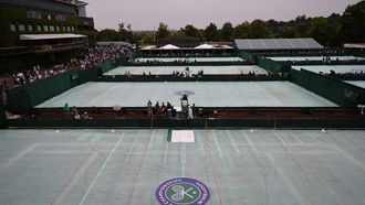 Outer courts are covered after a persistent rain started and stopped all outdoor play on day four of the 2013 Wimbledon Championships tennis tournament at the All England Club in Wimbledon, southwest London, on June 27, 2013. Rain forced the abandonment of play at Wimbledon on June 27 apart from centre court where they deployed the roof. AFP PHOTO / CARL COURT -  RESTRICTED TO EDITORIAL USE
CARL COURT / AFP