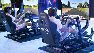 Visitors try out a race simulator before the start of the competition during the Olympics Esports Week in Singapore on June 22, 2023. 
Roslan RAHMAN / AFP