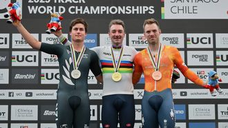 (L to R) New Zealand's  #33 Campbell Stewart (silver), Italy's #58 Elia Viviani (gold), and Netherlands' #60 Yoeri Havik (bronze) celebrate during the men's elimination event award ceremony at the 2025 UCI Track World Championships, in the Penalolen Velodrome in Santiago, on October 26, 2025. Italian cyclist Elia Viviani claimed the gold medal in the elimination race at the final Track World Cup of his professional career.
Javier TORRES / AFP