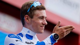 2023-09-16 17:59:19 Team Quick Step's Belgian rider Remco Evenepoel celebrates on the podium wearing the best climber jersey after the stage 20 of the 2023 La Vuelta cycling tour of Spain, a 207,8 km race between Manzanares el Real and Guadarrama, on September 16, 2023. 
Oscar DEL POZO / AFP