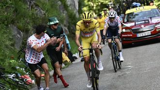 UAE Team Emirates team's Slovenian rider Tadej Pogacar wearing the overall leader's yellow jersey takes the lead as he cycles past Team Visma - Lease a Bike team's Danish rider Jonas Vingegaard in the final ascent of the Plateau de Beille during the 15th stage of the 111th edition of the Tour de France cycling race, 197,7 km between Loudenvielle and Plateau de Beille, in the Pyrenees mountains, southwestern France, on July 14, 2024. 
Marco BERTORELLO / AFP