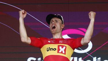 Uno X Mobility Norwegian rider Fredrik Dversnes celebrates on the podium after winning the 15th stage of the Giro d'Italia 2026 - Tour of Italy cycling race between Voghera and Milan, Italy, on May 24, 2026. 
Luca Bettini / AFP