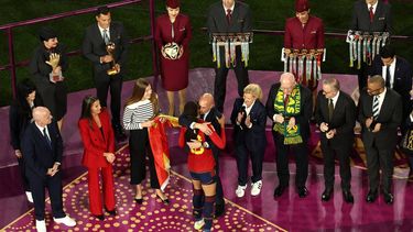 2023-08-20 16:10:07 President of the Royal Spanish Football Federation Luis Rubiales (C) embraces Spain's forward #18 Salma Paralluelo on the podium after Spain beat England to win the Australia and New Zealand 2023 Women's World Cup final football match at Stadium Australia in Sydney on August 20, 2023. 
DAVID GRAY / AFP