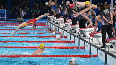 Swimmers compete in a heat of the mixed 4x100m medley relay swimming event during the Paris 2024 Olympic Games at the Paris La Defense Arena in Nanterre, west of Paris, on August 2, 2024. 
Jonathan NACKSTRAND / AFP