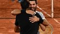 2022-06-04 20:21:44 Salvador's Marcelo Arevalo (L) and Netherlands' Jean-julien Rojer (R) greet each others after winning against Croatia's Ivan Dodig and Austin Krajicek of the US at the end of their men's doubles final match on day fourteen of the Roland-Garros Open tennis tournament at the Court Philippe-Chatrier in Paris on June 4, 2022. 
Anne-Christine POUJOULAT / AFP
