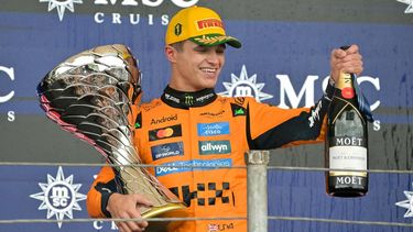 McLaren's British driver Lando Norris celebrates with the trophy and champagne after winning the Sao Paulo Formula One Grand Prix at the Jose Carlos Pace racetrack, aka Interlagos, in Sao Paulo, Brazil on November 9, 2025. 
Nelson ALMEIDA / AFP