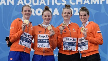 2022-08-11 20:26:26 Members of The Netherlands' team (From L) Marrit Steenbergen, Janna van Kooten, Silke Holkenborg and Imani De Jong celebrate on the podium with their Gold medal after winning the Women's 4 x 200m freestyle final event on August 11, 2022 during the LEN European Aquatics Championships in Rome. 
Filippo MONTEFORTE / AFP