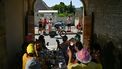 XDS Astana Team's Dutch rider Cees Bol cycles past spectators eating at a table along the race route during the 5th stage of the 112th edition of the Tour de France cycling race, 33 km individual time trial starting and finishing in Caen, northwestern France, on July 9, 2025. 
Loic VENANCE / AFP