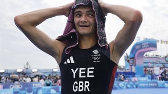 epa11511446 Alex Yee of Great Britain celebrates after the Men Individual race of the Triathlon competitions from a Metro entrance in the Paris 2024 Olympic Games, at the Pont Alexandre III in Paris, France, 31 July 2024.  EPA/TOLGA AKMEN