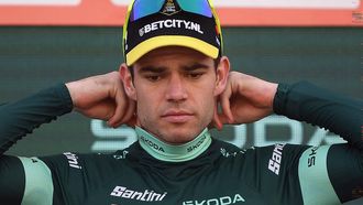 The points ranking leader, Team Visma's Wout van Aert, puts on the green jersey on the podium after the stage 9 of the Vuelta a Espana, a 178,5 km race between Motril and Granada, on August 25, 2024.   
Jorge GUERRERO / AFP
