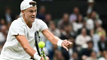 Denmark's Holger Rune returns the ball to Serbia's Novak Djokovic during their men's singles tennis match on the eighth day of the 2024 Wimbledon Championships at The All England Lawn Tennis and Croquet Club in Wimbledon, southwest London, on July 8, 2024. 
Ben Stansall / AFP