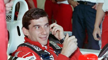 New world champion Ayrton Senna of Brazil smiles to his staff members in the pit during the final qualifying for the Australian F1 Grand Prix in Adelaide on November 12, 1988. 
AFP