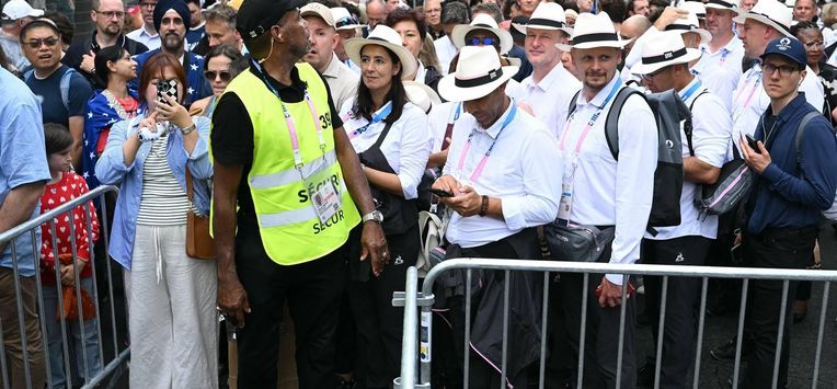 People queue outside the security perimeter as they arrive to attend the opening ceremony of the Paris 2024 Olympic Games in Paris on July 26, 2024. 
Natalia KOLESNIKOVA / AFP