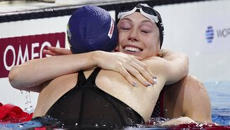 epa11775482 Gretchen Walsh (R) of the US smiles after she came in first in the semifinal of women's 100m butterfly of the World Aquatics Swimming Championships in Budapest, Hungary, 13 December 2024.  EPA/Robert Hegedus HUNGARY OUT
