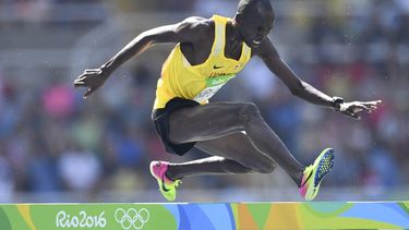 Uganda's Benjamin Kiplagat competes in the Men's 3000m Steeplechase Round 1 during the athletics event at the Rio 2016 Olympic Games at the Olympic Stadium in Rio de Janeiro on August 15, 2016.   
Fabrice COFFRINI / AFP