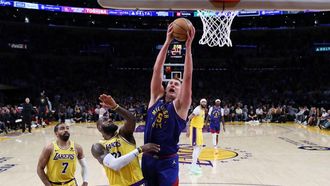 epa11301725 Denver Nuggets center Nikola Jokic (R) drives to the basket next to Los Angeles Lakers guard Gabe Vincent (L) and forward LeBron James during the fourth quarter of the NBA Western Conference first round playoff game between the Denver Nuggets and Los Angeles Lakers in Los Angeles, California, USA, 25 April 2024.  EPA/CAROLINE BREHMAN SHUTTERSTOCK OUT