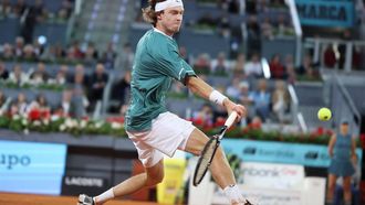 Russia's Andrey Rublev returns the ball to Spain's Carlos Alcaraz during the 2024 ATP Tour Madrid Open tournament quarter-final tennis match at Caja Magica in Madrid on May 1, 2024. 
Thomas COEX / AFP