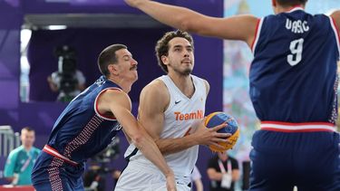 Netherlands' #04 Jan Driessen (C) tries to shoot past Serbia's #03 Strahinja Stojacic and Serbia's #09 Mihailo Vasic (R) in the men's pool round 3x3 basketball game between the Netherlands and Serbia during the Paris 2024 Olympic Games at La Concorde in Paris on August 1, 2024. 
David GRAY / AFP