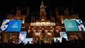 This photograph taken on November 28, 2023, shows a banner and a lettering display in the graphic design of the Paris 2024 Olympic and Paralympic Games, with the city logo and reading 